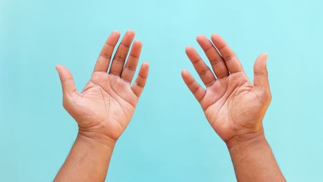 two human hands raised upwards with palms open