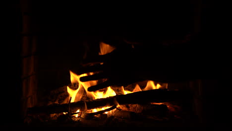 warming hands in the fire in the fireplace