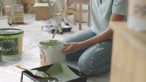 woman painting walls in a home renovation