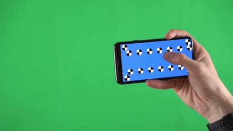 closeup footage of a smartphone in horizontal orientation with tracking points and man sliding pages