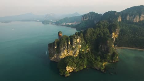 astonishing half turn aerial shot of limestone cliffs on a mountainous tropical island