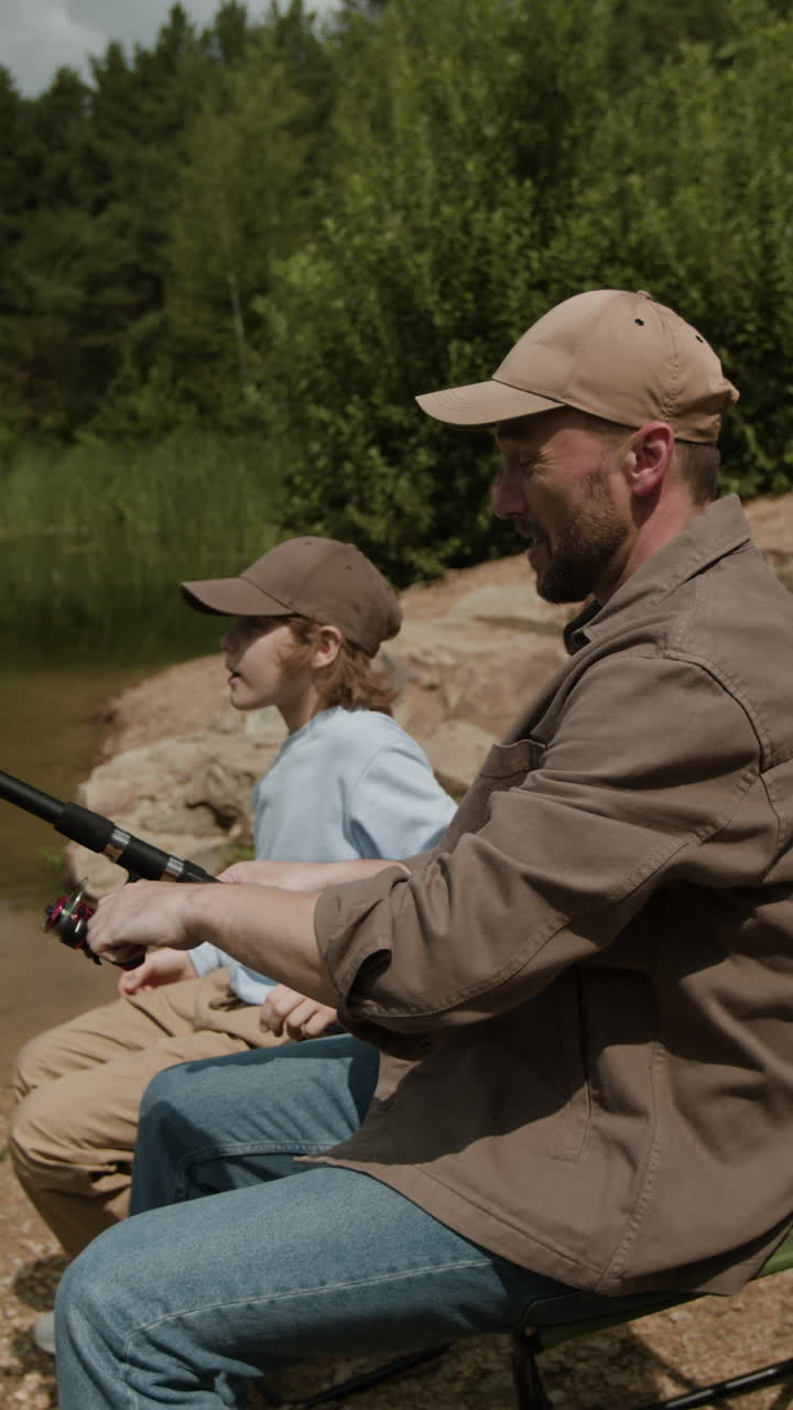 Father and son fishing by the lake