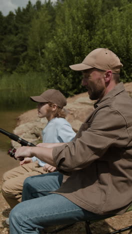 father and son fishing by the lake