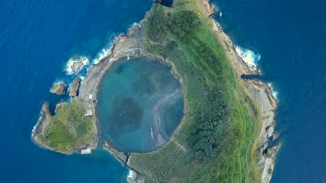 aerial vertical drone footage of a tropical and prehistoric island located in sao miguel, azores