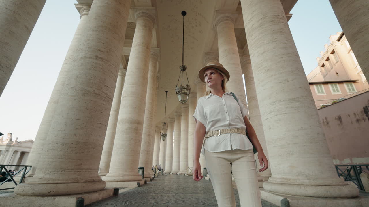 Woman Walking Under Columns in St. Peter's Square