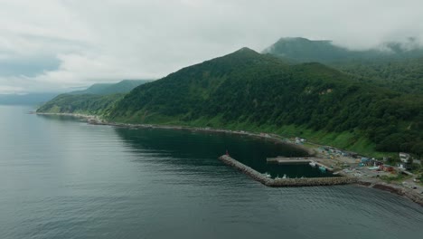 aidomari fishing port on rugged coast of rebun island, shiretoko peninsula, hokkaido, japan. wide aerial shot