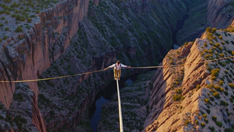 daredevil slacklining across a canyon