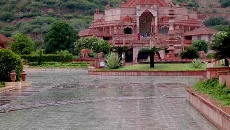 artistic-red-stone-jain-temple-at-morning-from-unique-angle-video-is-taken-at-Shri-Digamber-Jain-Gyanoday-Tirth-Kshetra,-Nareli-Jain-Mandir,-Ajmer,-Rajasthan,-India-an-Aug-19-2023.