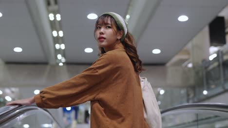 4k asian woman go to boarding gate in airport terminal.