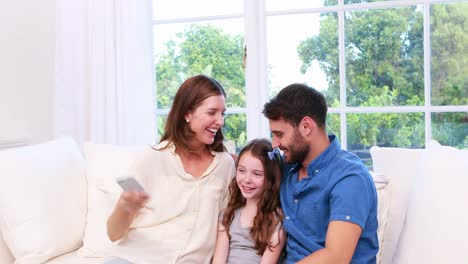 Happy-family-with-daughter-taking-selfie