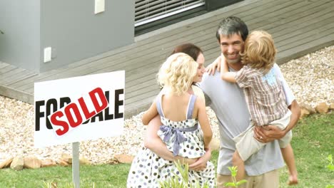 Young-family-in-front-of-their-new-house