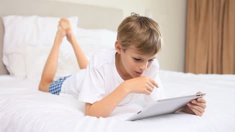 smiling boy touching a tablet computer