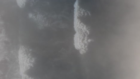 a spiraling drone shot of waves crashing by in the fog on the oregon coast, moody and relaxing ocean