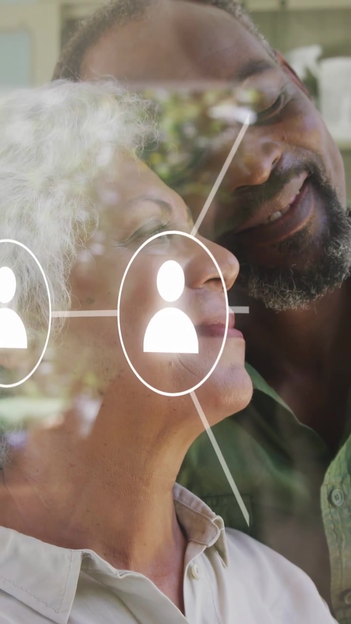 Vertical video: Older couple glass icon popping by man nodes growing into network linking them tech