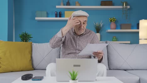 Elderly-businessman-looks-at-paperwork-at-home-and-is-thoughtful.