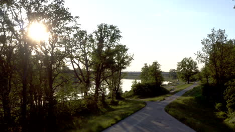 aerial shot rising up above a wide calm river