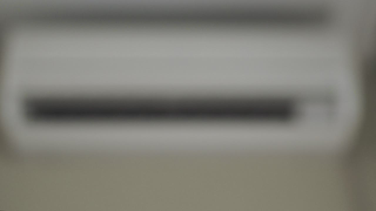 Turning on the air conditioner with remote control. Close-up.