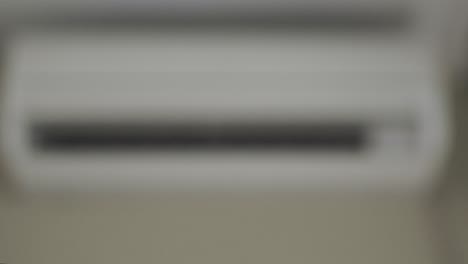 turning on the air conditioner with remote control. close-up.