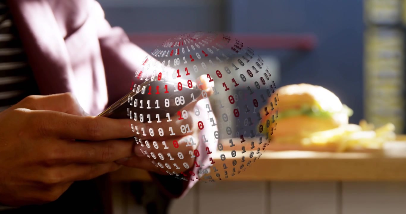 Man tapping smartphone at cafe counter, summoning binary globe wrapping phone for technology demo