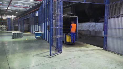 worker operating a forklift inside a factory