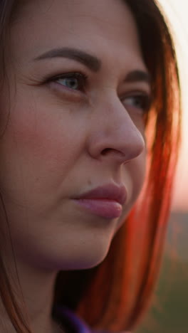 sorrowful woman facial expression at sunset closeup. attractive lady suffers from loneliness at twilight countryside. melancholic thoughts and moods