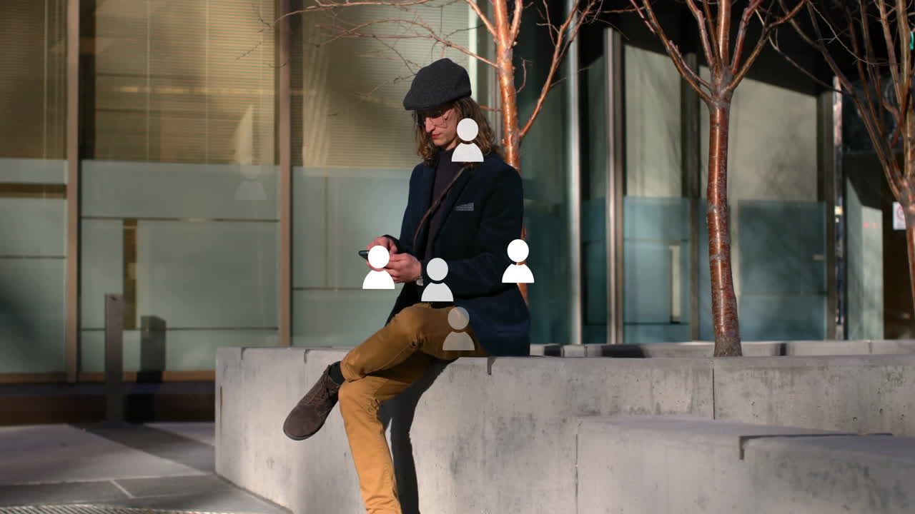 Using phone outdoors, man engaging with animation of social media icons