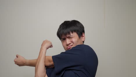 Young-man-stretching-shoulders,-neck-and-back