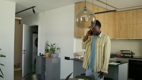 man talking on phone in modern kitchen