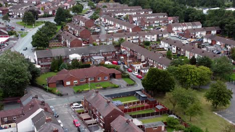 aerial view above british neighbourhood small town residential suburban property gardens and town streets