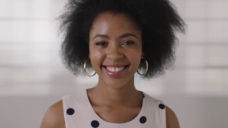 close up portrait of beautiful young african american business woman smiling happy successful black female afro hairstyle
