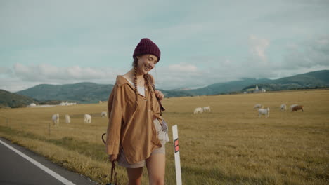 young woman exploring by cows grazing in farm