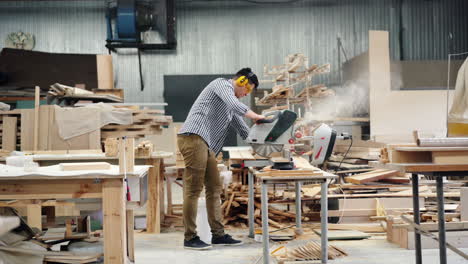 woodworker using circular saw in workshop