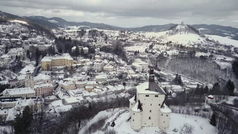 aerial shot of a new castle in mining town banska stiavnica in winter, cloudy