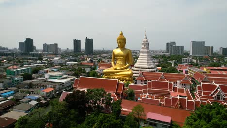 golden buddha statue wat paknam bhasicharoen in phasi charoen old district in bangkok, thailand - aerial parallax