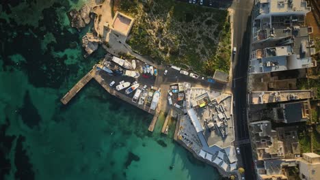 Up-direction-Spiral-drone-shot-over-boat-yard-in-Mellieha-bay-Malta