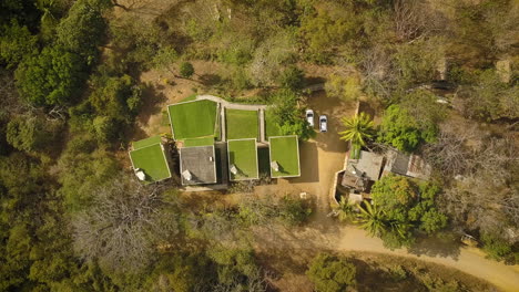 Aerial-view-of-modern-grass-rooftops-on-a-tropical-beach