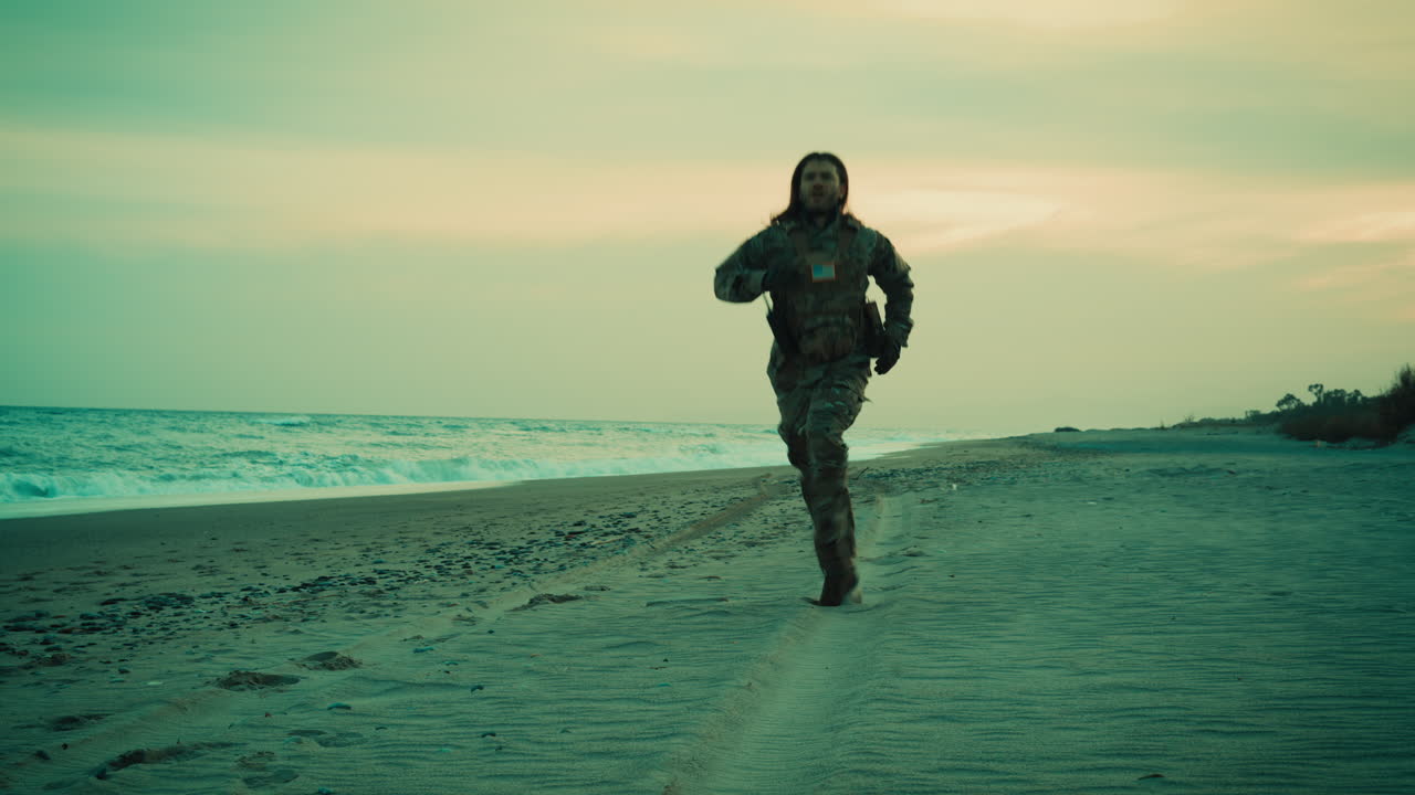 American Soldier Runs on Beach Near Ocean