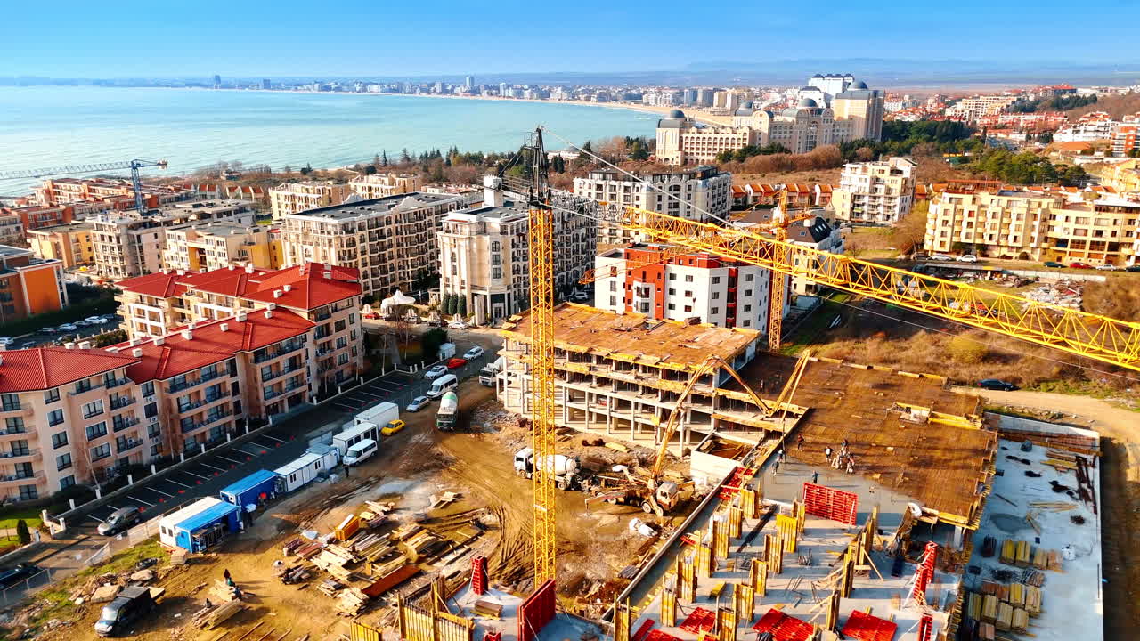 Vista panoramica dello sviluppo urbano costiero e di un cantiere. Ripresa con drone grandangolare della costa cittadina e dei nuovi edifici.
