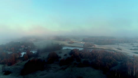 Clouds-over-forests-and-green-rural-fields,-forward-aerial-hyperlapse