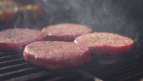 close up shot of perfect burgers sizzling on the grill on a summer day