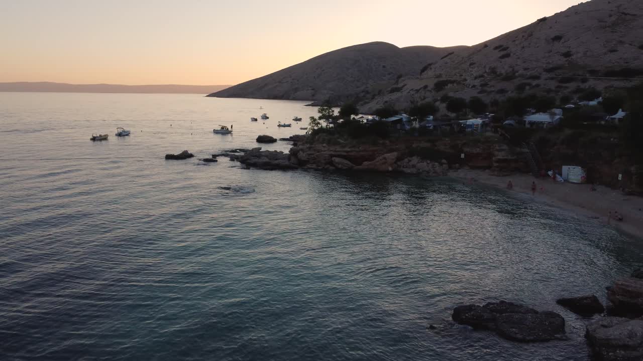 Beautiful flying overview of Stara Baska Beach Camp and trailer park on Krk Island at sunset in Croatia