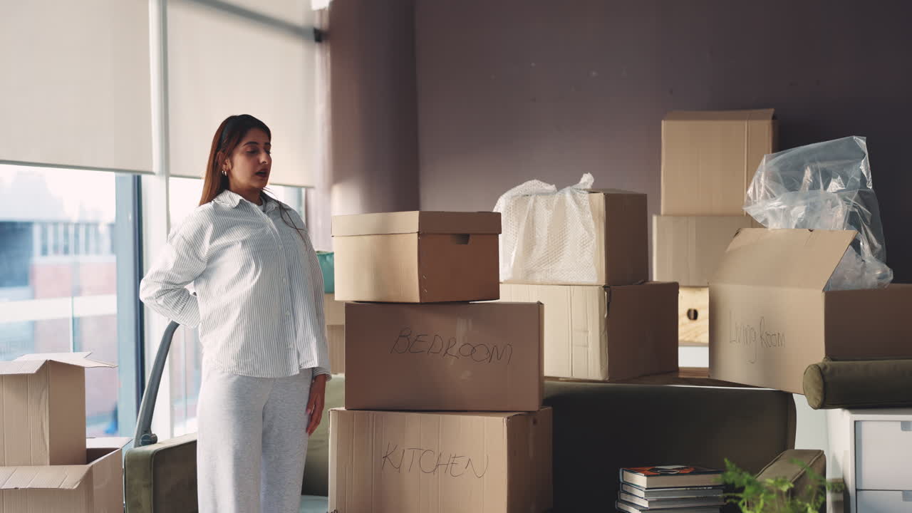 Woman moving house with boxes
