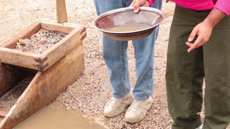 two people panning for gold together