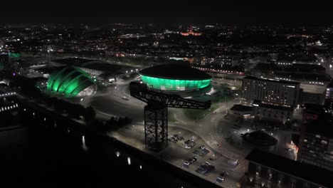 aerial night view of glasgow's illuminated ovo hydro and sec armadillo with finnieston crane