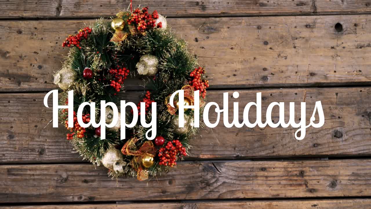 Happy holidays text and Christmas wreath