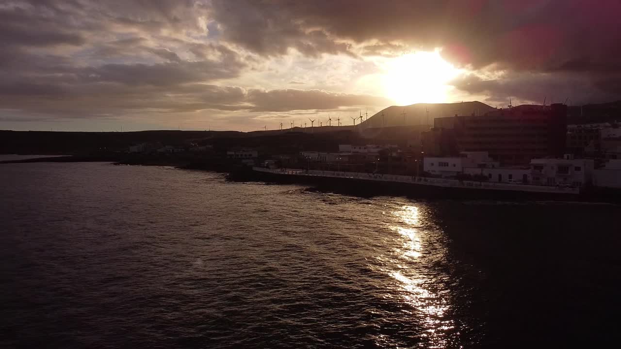 Bela vista aérea do oceano com silhueta de veleiro e costa da ilha de Tenerife durante a hora dourada do pôr do sol de verão