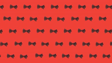 Animation-of-bow-ties-floating-over-red-background