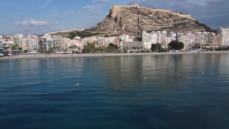 nice aerial view of the beach and castle of alicante, spain