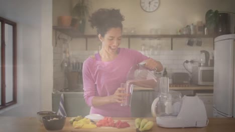 Animation-of-financial-data-processing-over-biracial-woman-in-kitchen