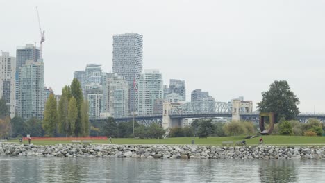 Bridge,-buildings-and-seawalk-with-tiny-people-on-it